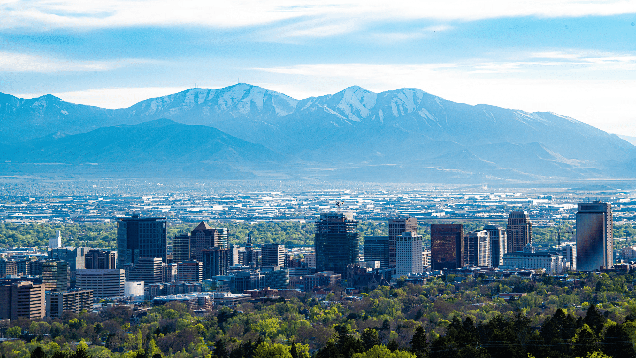 A Salt Lake City skyline with mountains in the background.