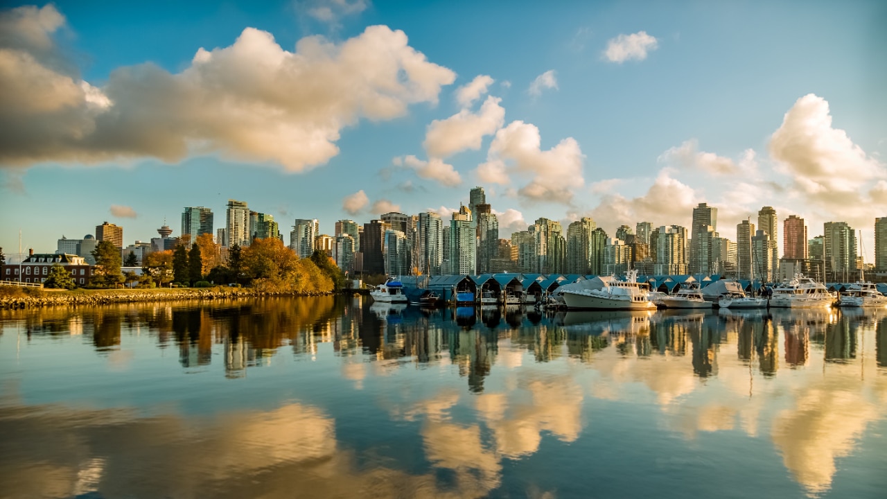 The skyline of Vancouver is reflected in the water during the marathon.