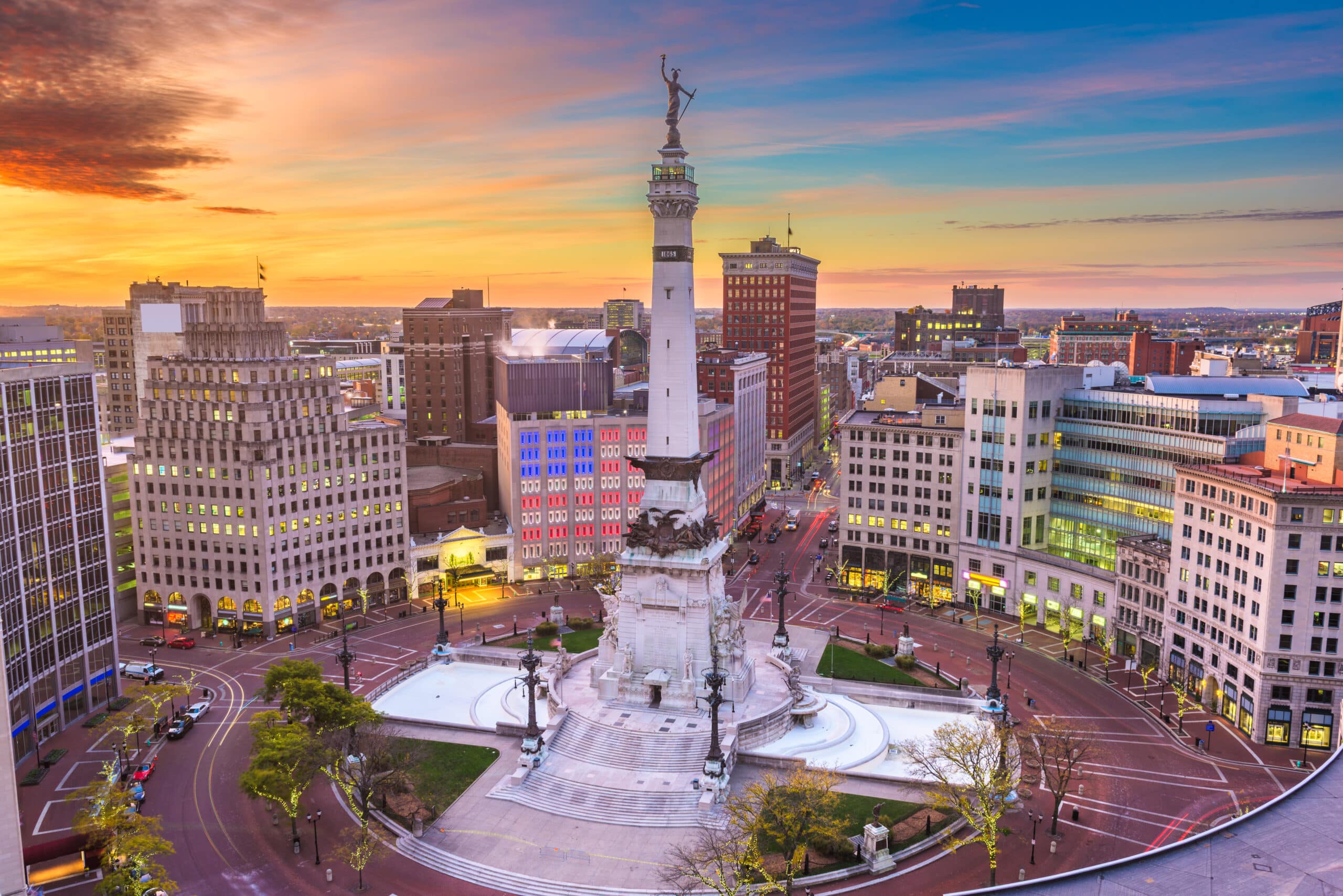 Indianapolis, Indiana, USA downtown cityscape and Monument Circle at dawn.