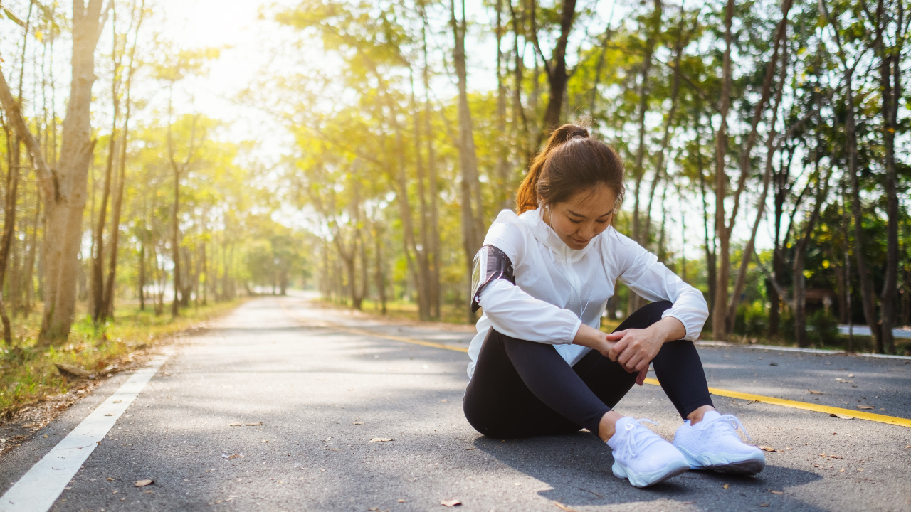 Female runner sitting down looking tired